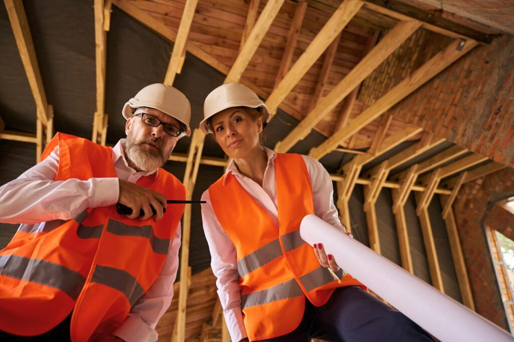 Contractor and building inspector posing for camera during home inspection